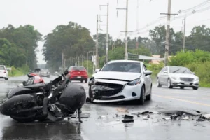 Car and motorcycle accident due to wet weather conditions