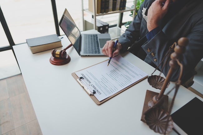 Scales of justice beside legal documents symbolizing fair compensation after a car accident.