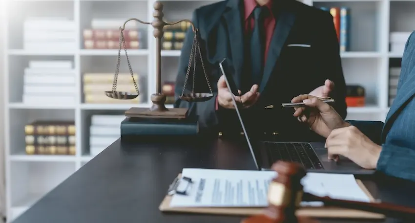 Experienced lawyer reviewing car accident case files and medical evidence for trial preparation