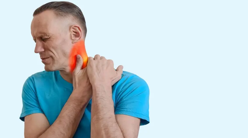 A man in a teal shirt is grimacing and gripping the inflamed neck area highlighted in red showing acute neck injury accident pain in Atlanta.