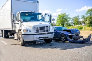A truck crashing into a car on the side of the road represents a case where a truck accident lawyer will have to help a victim.